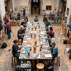 A group of people sitting at tables.