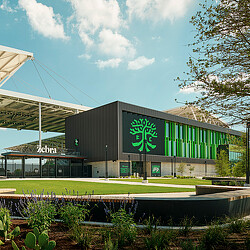 A building with a green lawn.