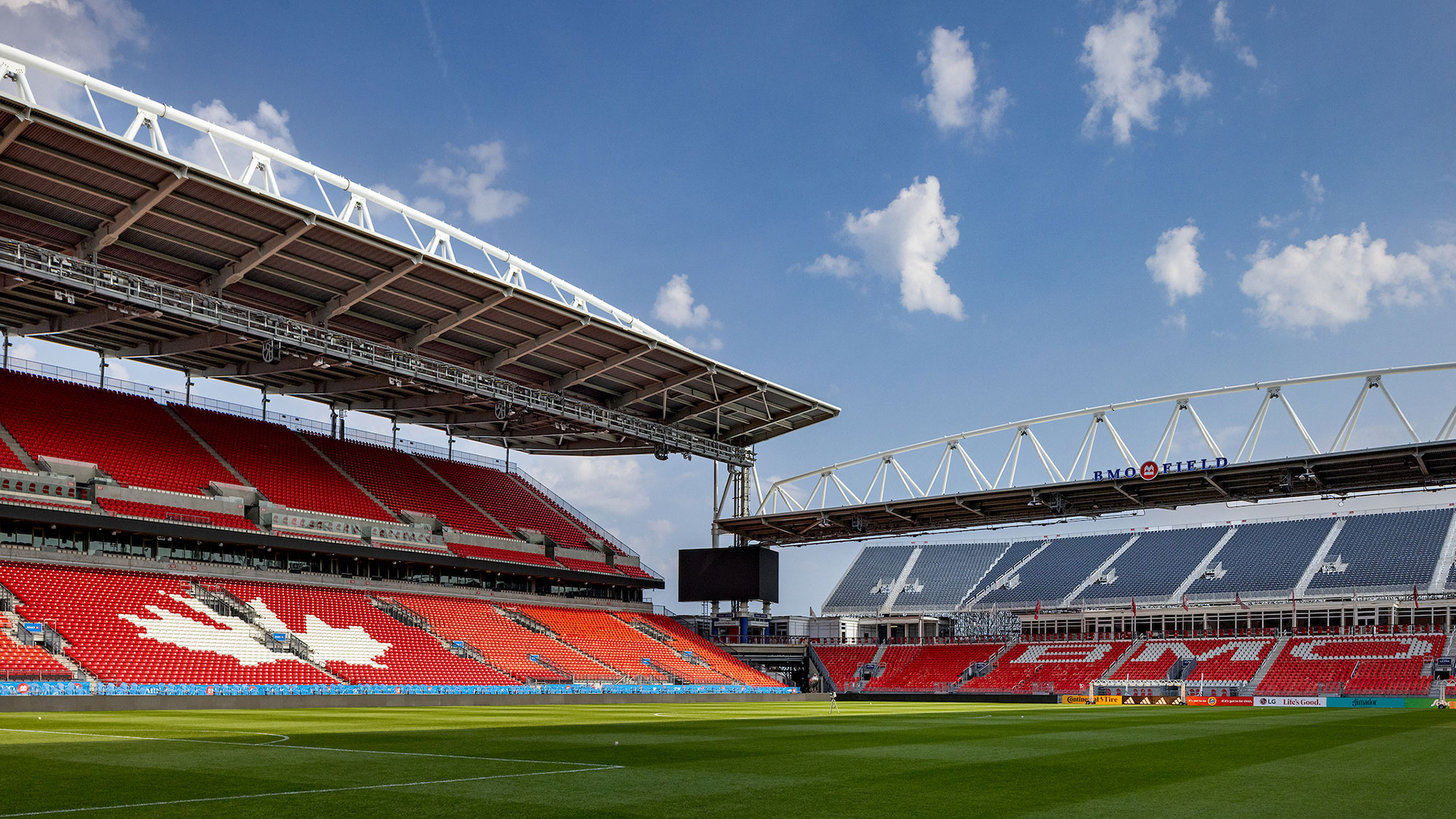 A large stadium with a field and a field.