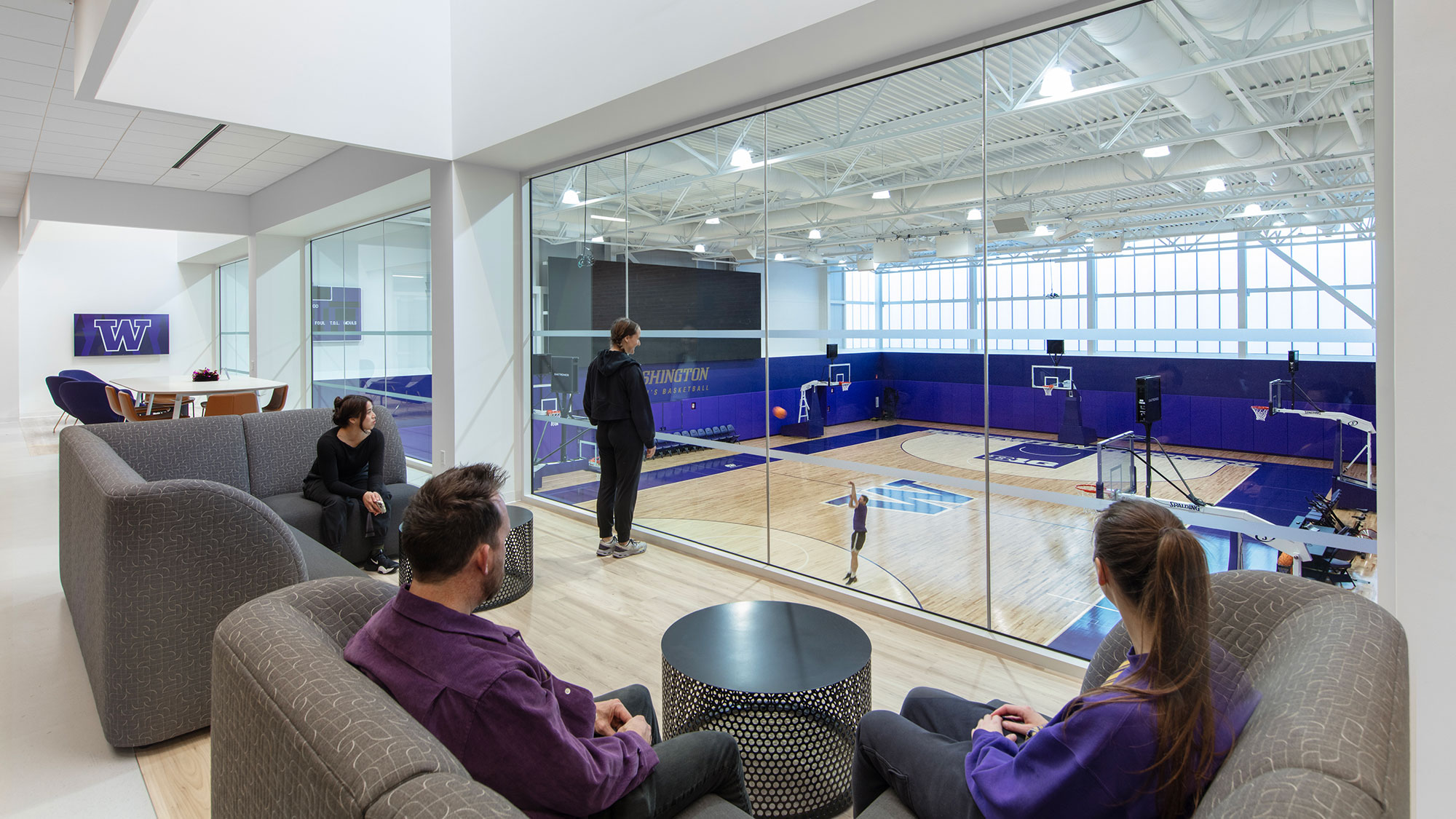 A group of people sitting in a room with a large pool.