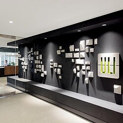A large black wall with a sign on it.