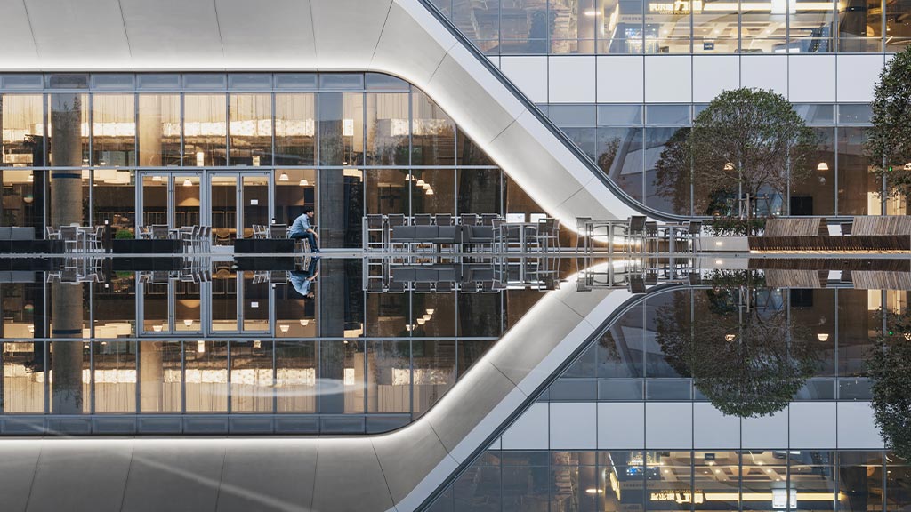 A person climbing a glass building.