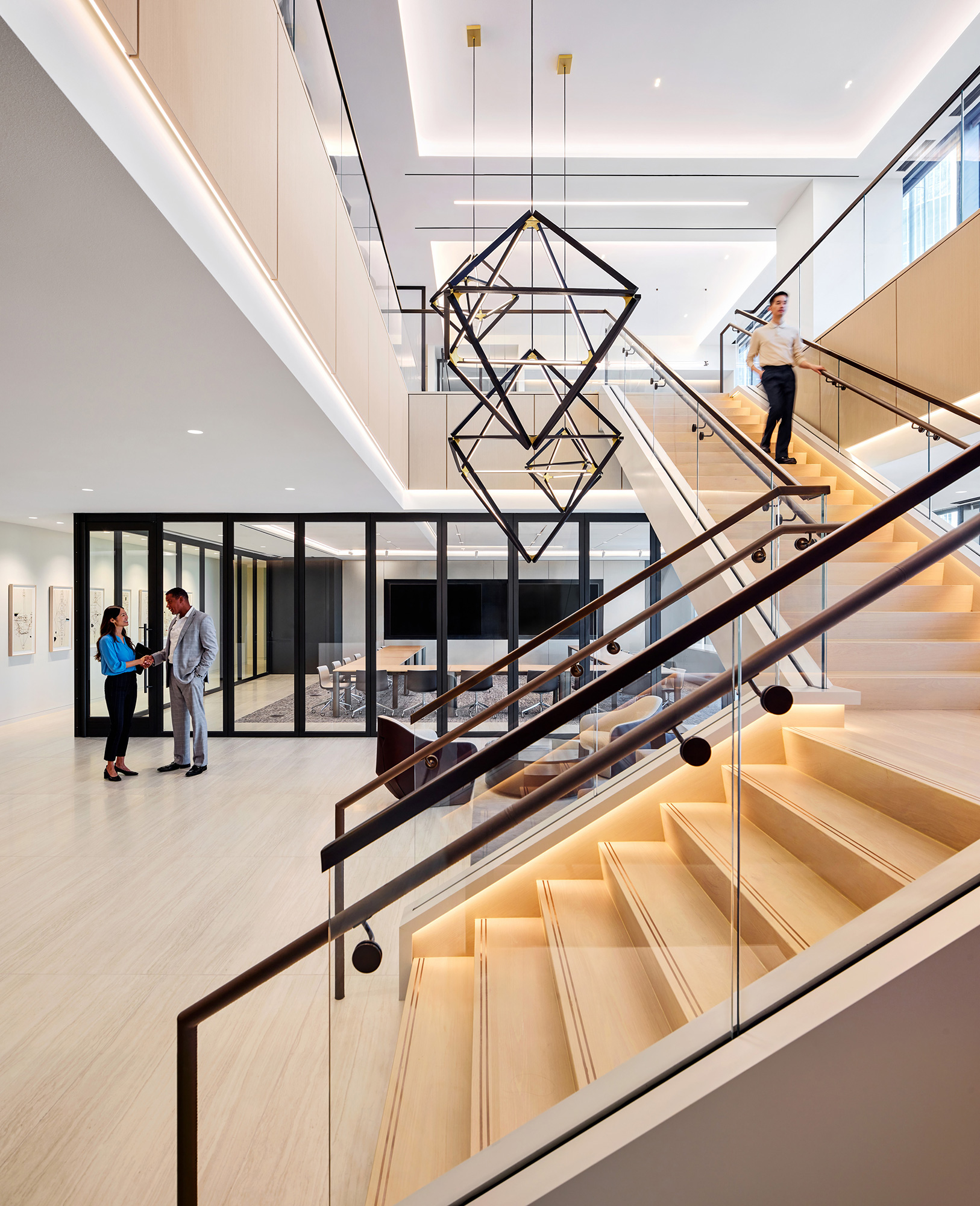 A few people walking up a staircase.