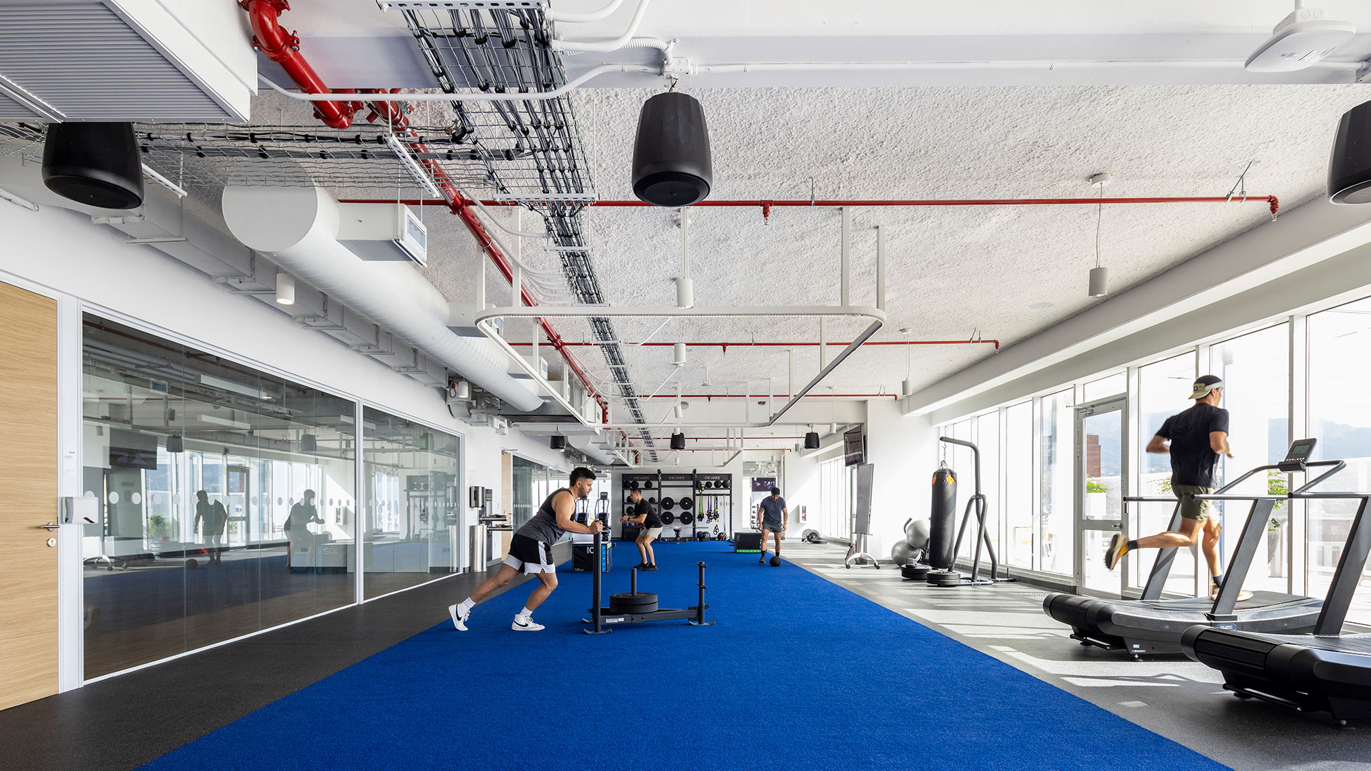 A person running on a trampoline in a gym.