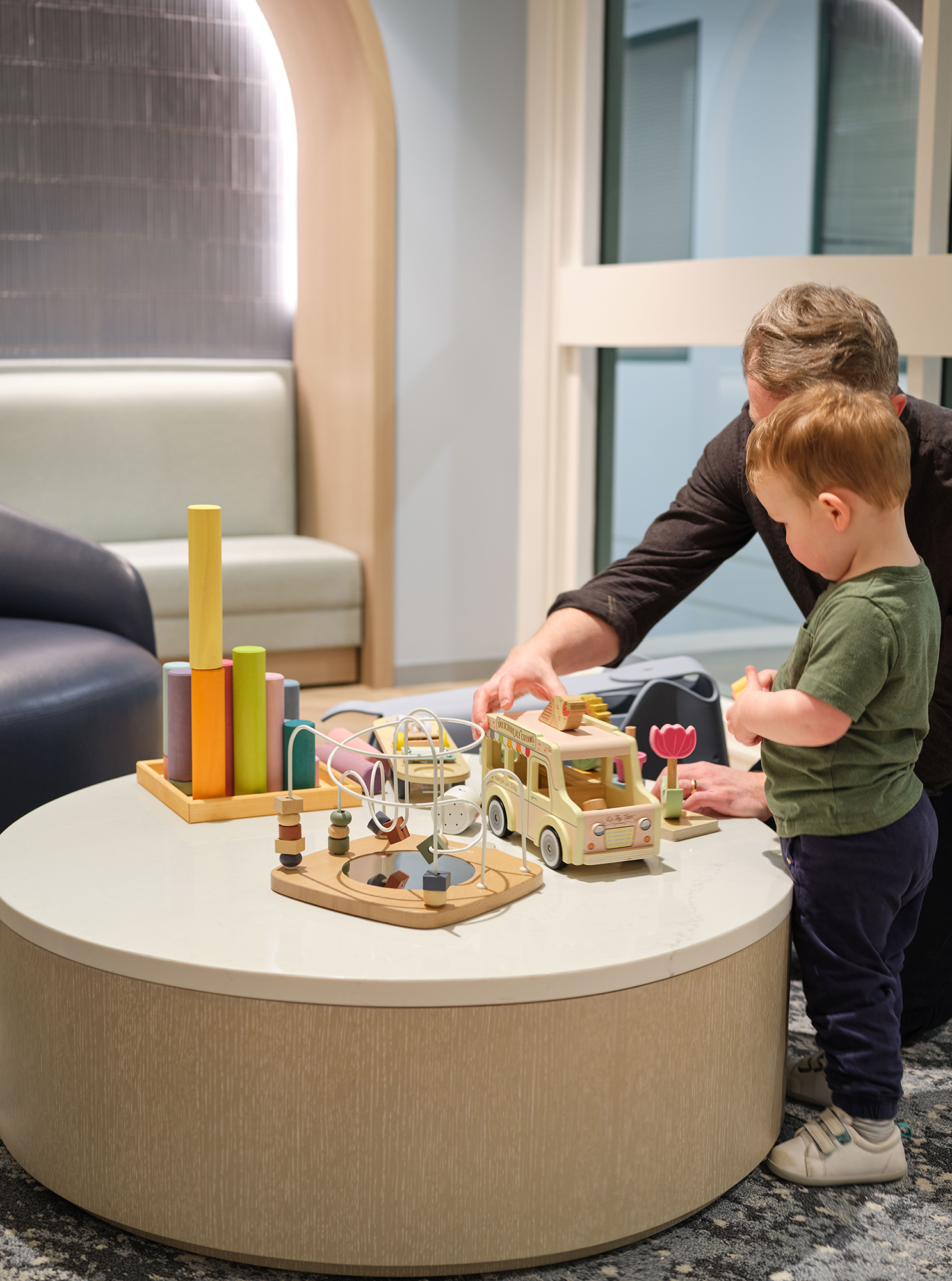 A couple of boys playing with a cake on a table.