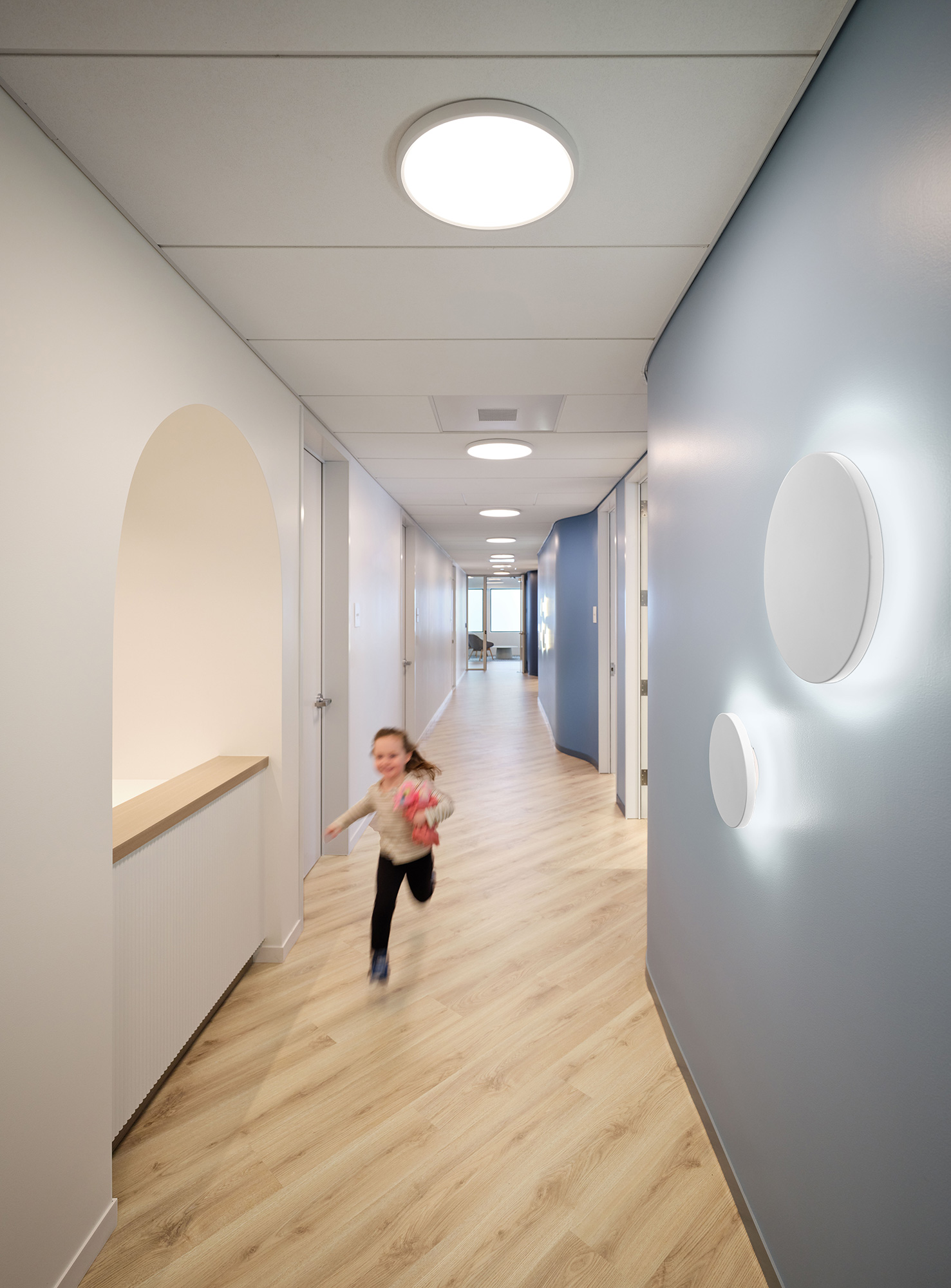 A girl running in a hallway.