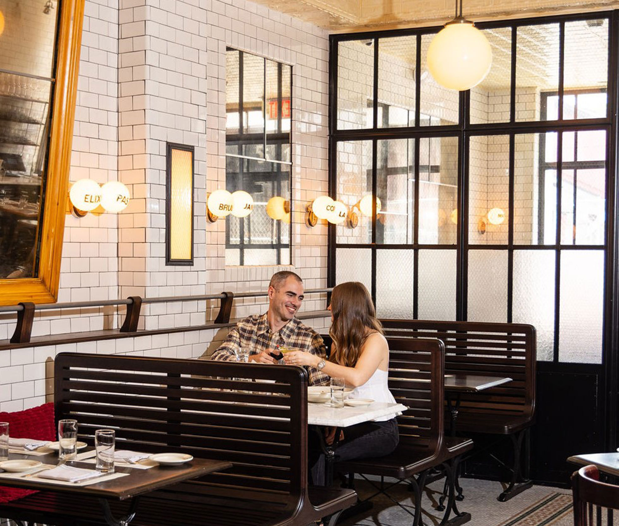 A man and a woman sitting at a table in a restaurant.