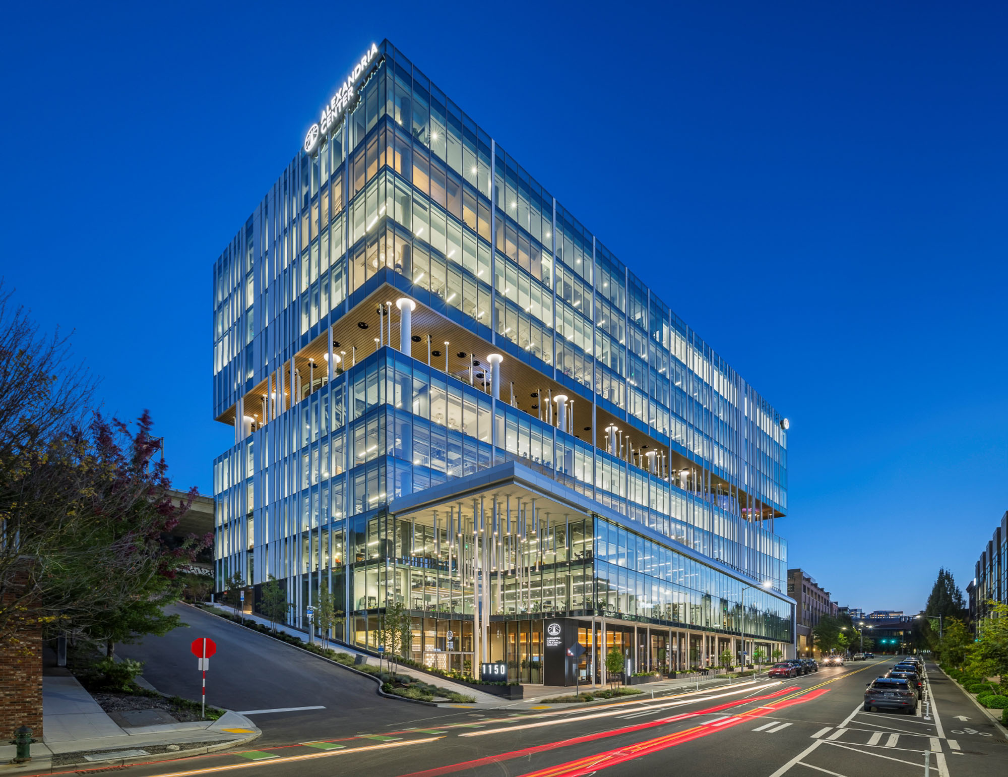 A building with a road and cars.