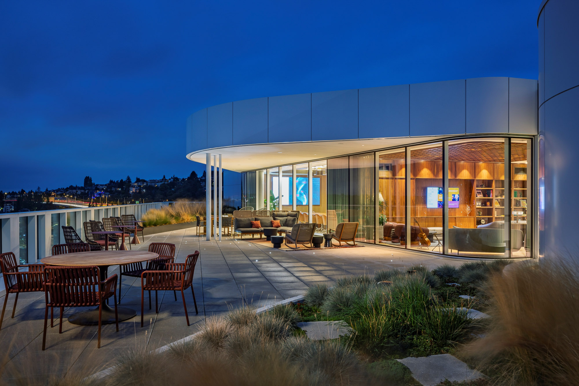 A building with tables and chairs outside.