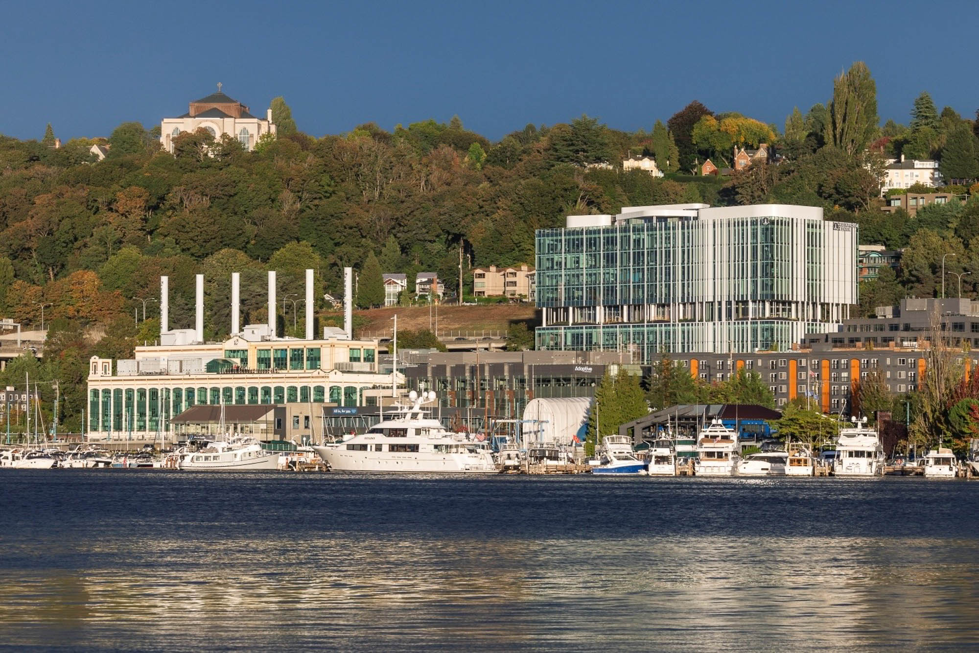 A body of water with boats and buildings along it.