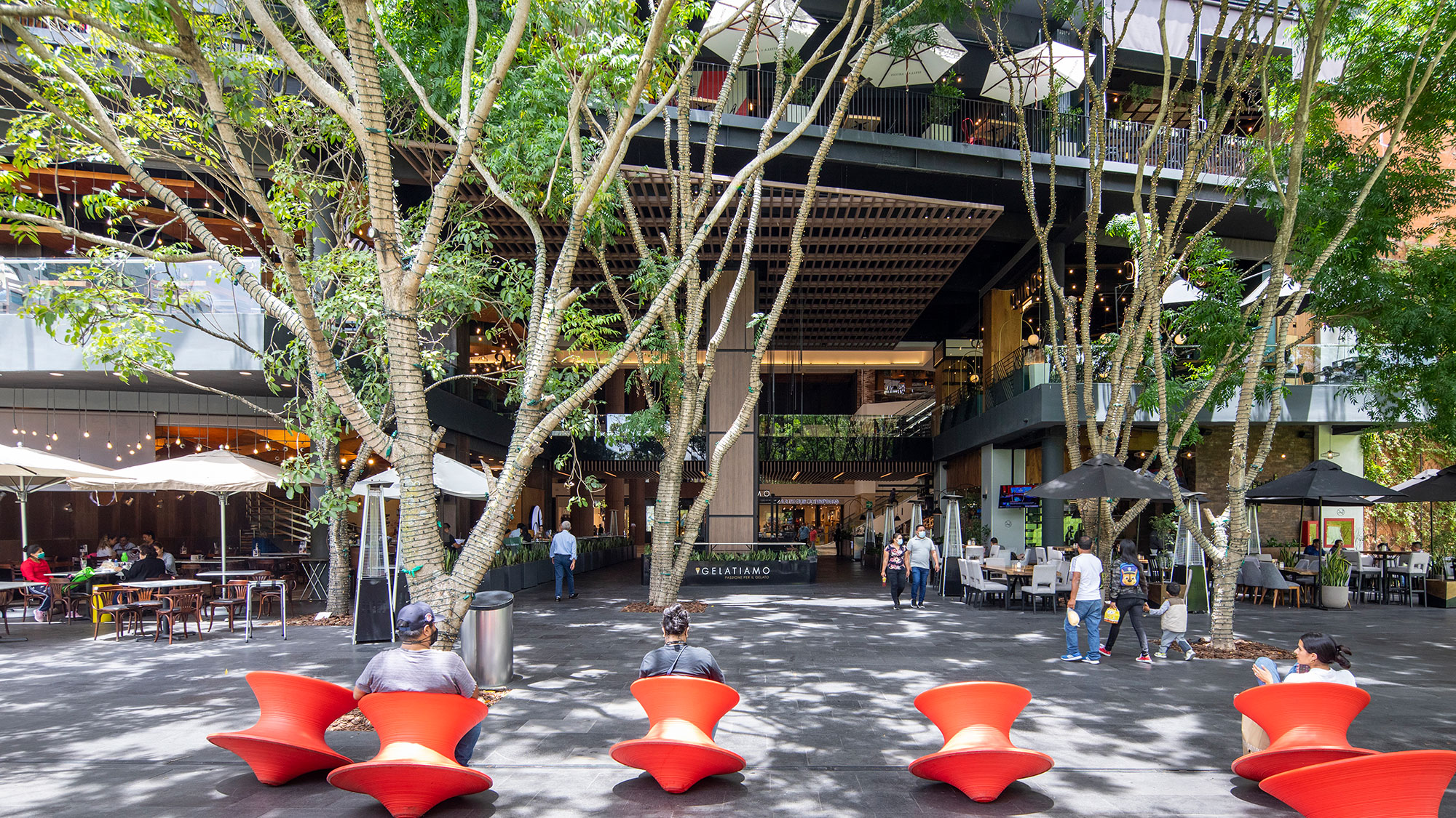 A group of people sitting in chairs outside of a building.