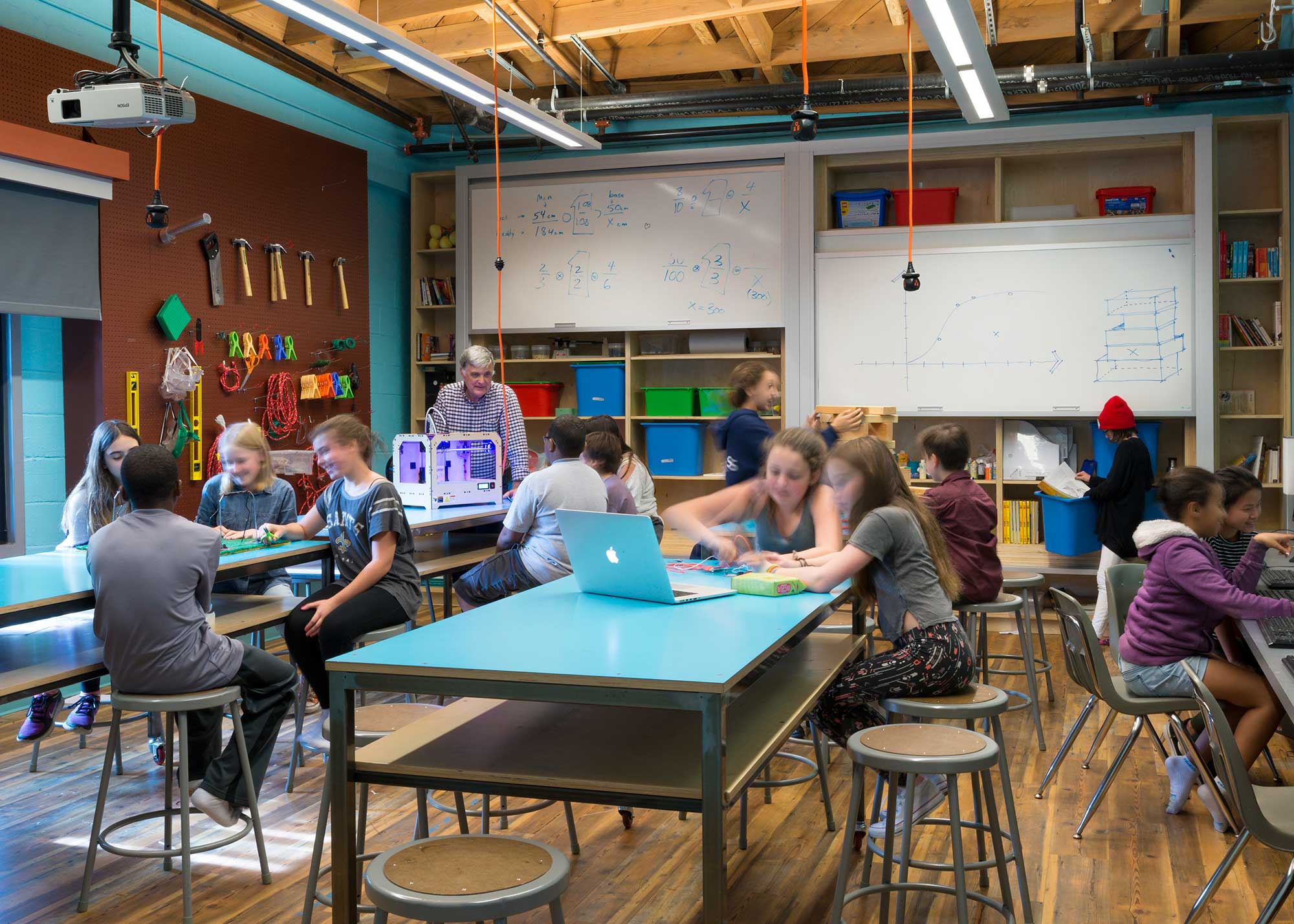 A group of people sitting at tables.