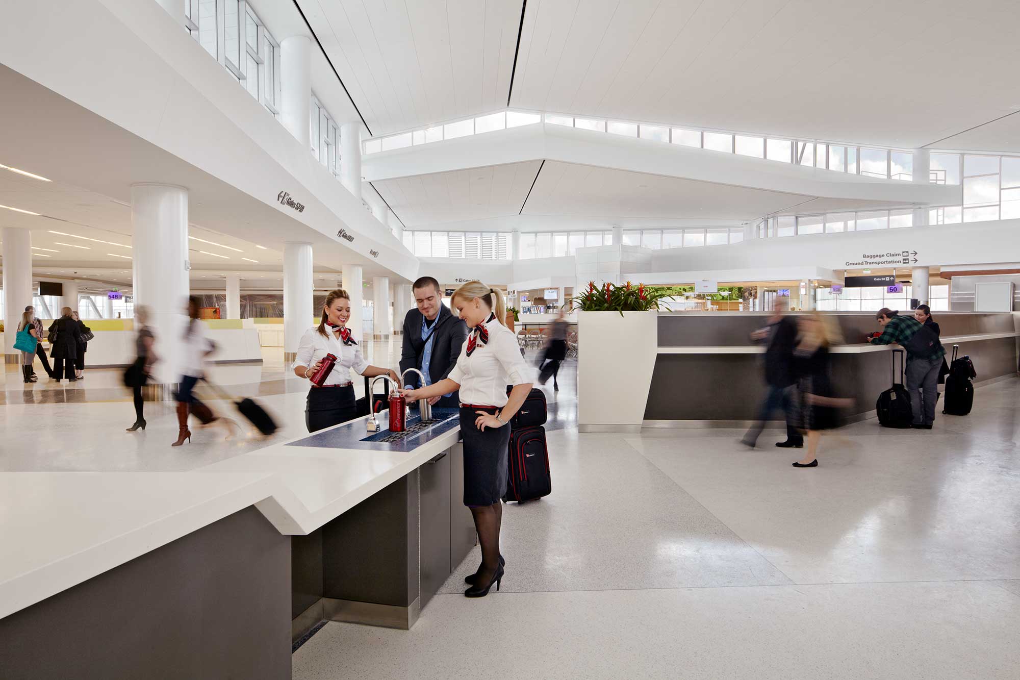 A group of people standing in an airport.