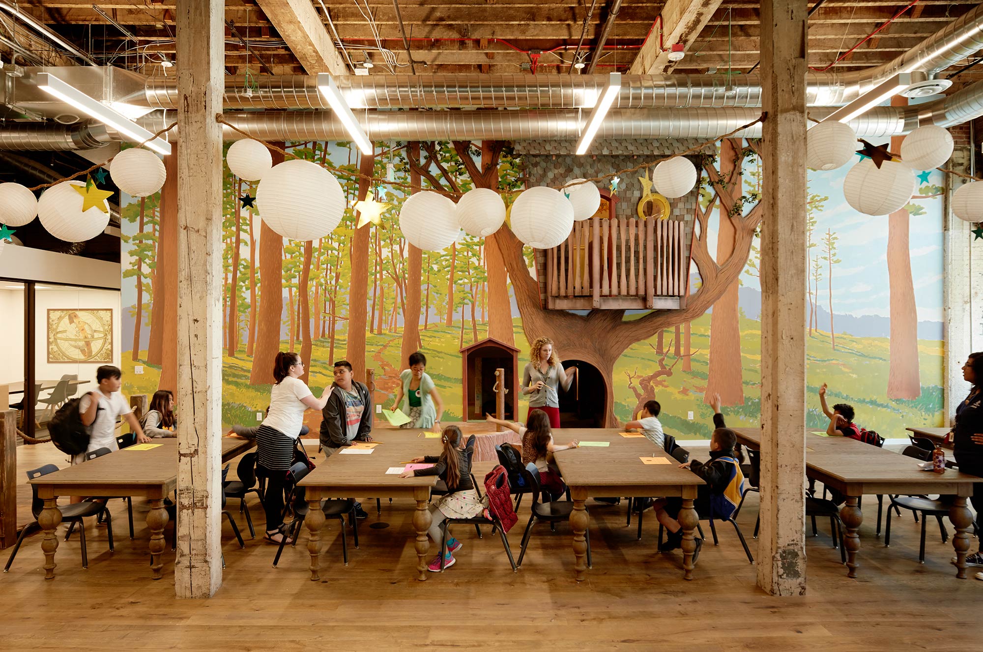 A group of people sitting at tables.