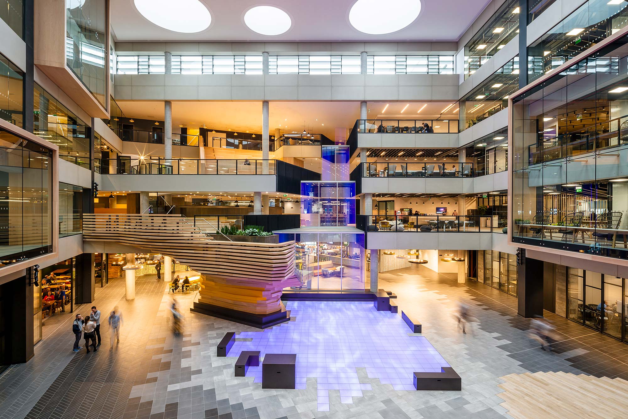 A large indoor mall with people and shopping carts.