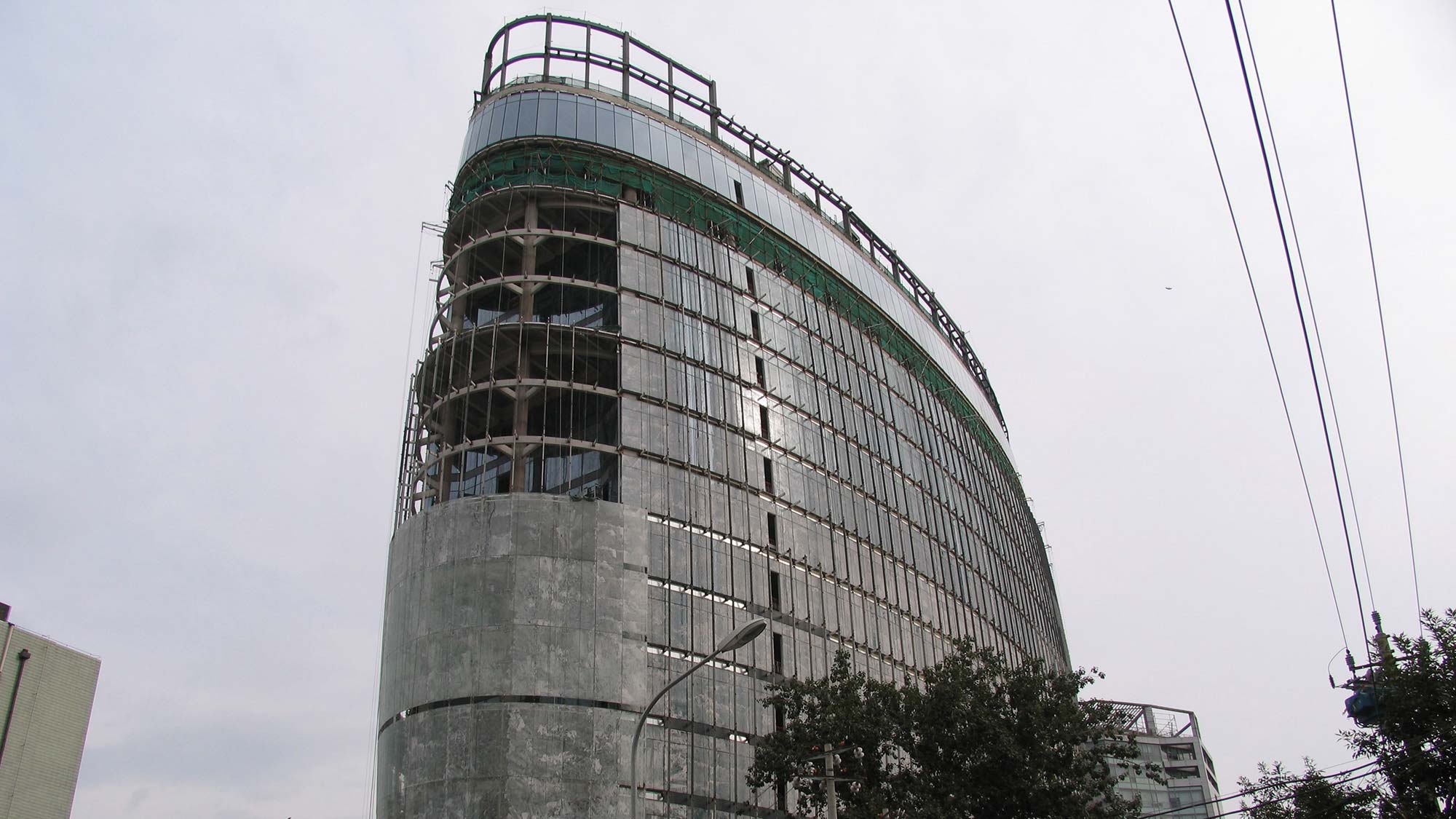 A tall building with a glass front.