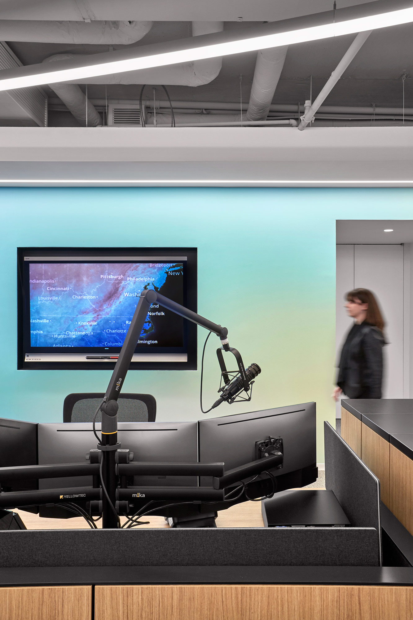 A person standing in front of a projector screen.