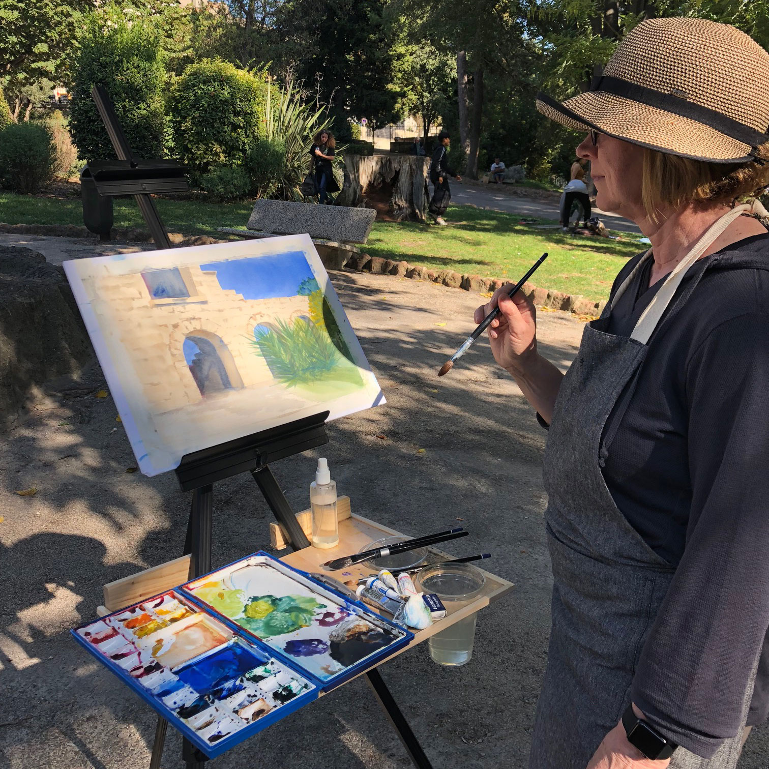 A person painting outside.