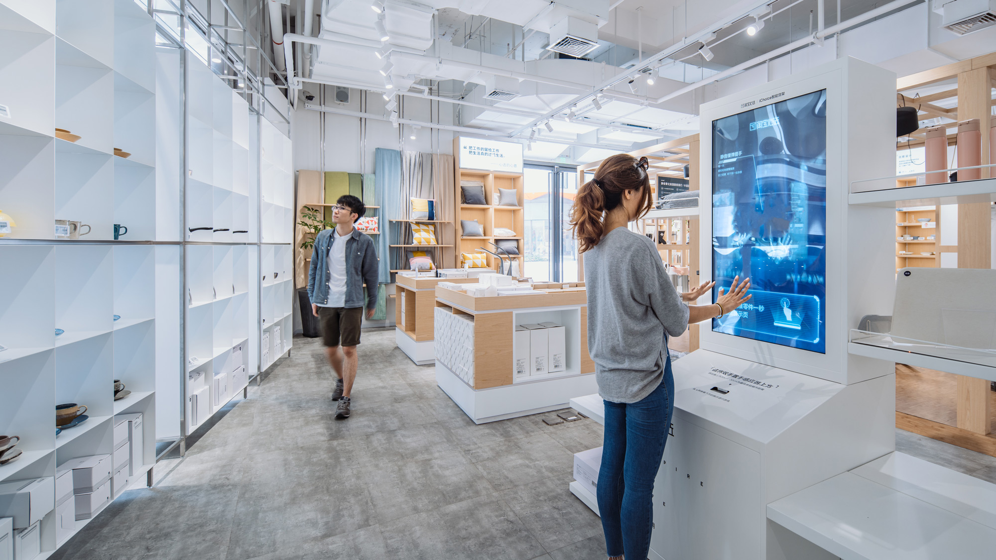 A shopper holds a product in front of a digital kiosk in the Taobao Choice Store.