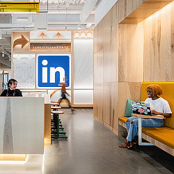 LinkedIn Omaha cafe-style seating with LinkedIn logo on wall.