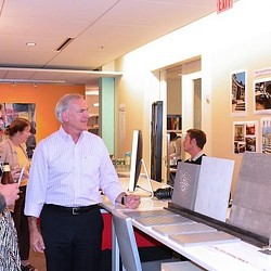 A man standing in front of a computer.