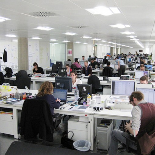 A group of people sitting at computers.