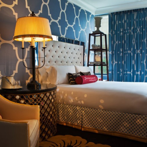 A bed with a lamp on the side.
