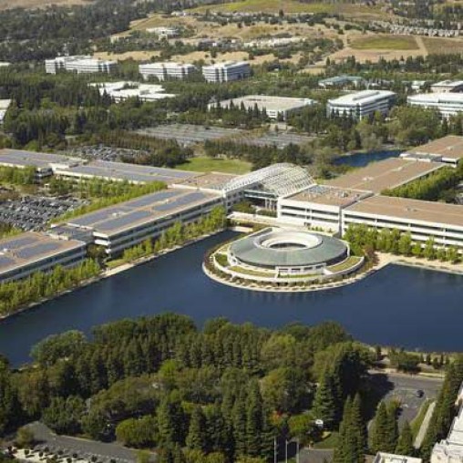 A large building with a pool in front of it.