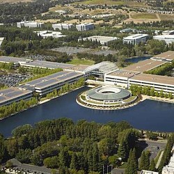 A large building with a pool in front of it.