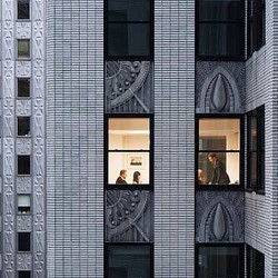 A couple of people looking out a window.