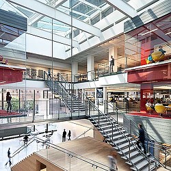 A large building with stairs and people.