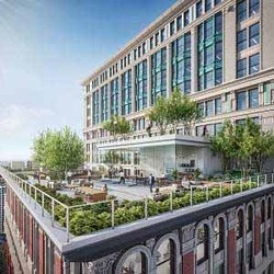 A building with a bridge and trees.