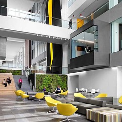 A group of people sitting on yellow chairs in a building.