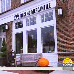 A building with a pumpkin in front of it.