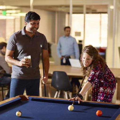 A man and a woman playing pool.