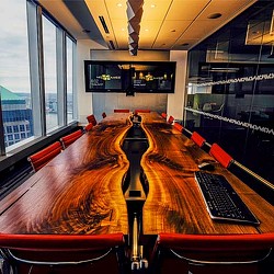 A table with a keyboard and a monitor on it.