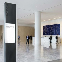 A group of people walking in a large building.