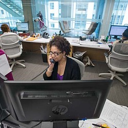 A person on a phone in an office.