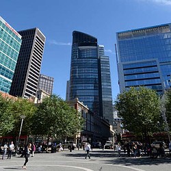 A group of people walking in a city.