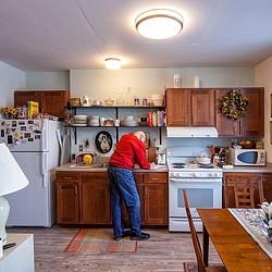 A person standing in a kitchen.