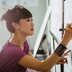 A woman holding a bow and arrow.
