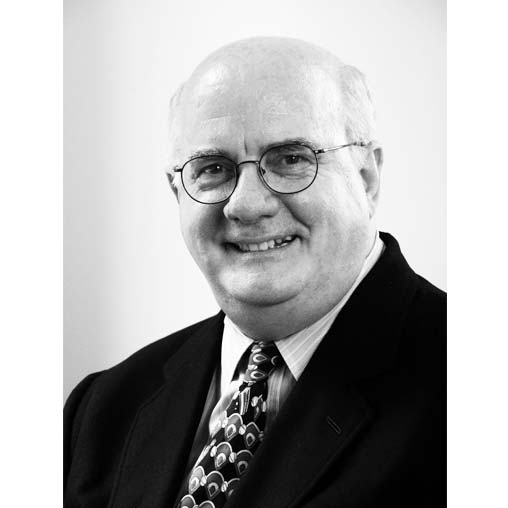 A man wearing glasses and a suit.