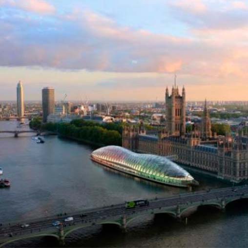 A bridge over a river with a city in the background.