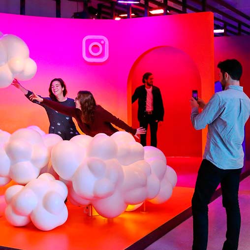 A group of people on a stage with balloons.