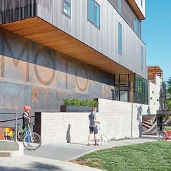 A man and a woman standing outside a building.