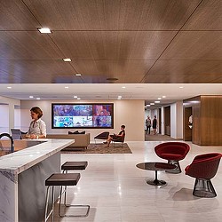 A room with a tv and chairs.