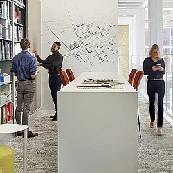 A few people standing in a room.