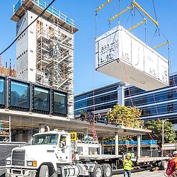 A crane lifting a large sign.