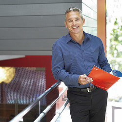 A person holding a red and blue flag.