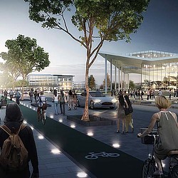 A group of people walking on a street with a building in the background.